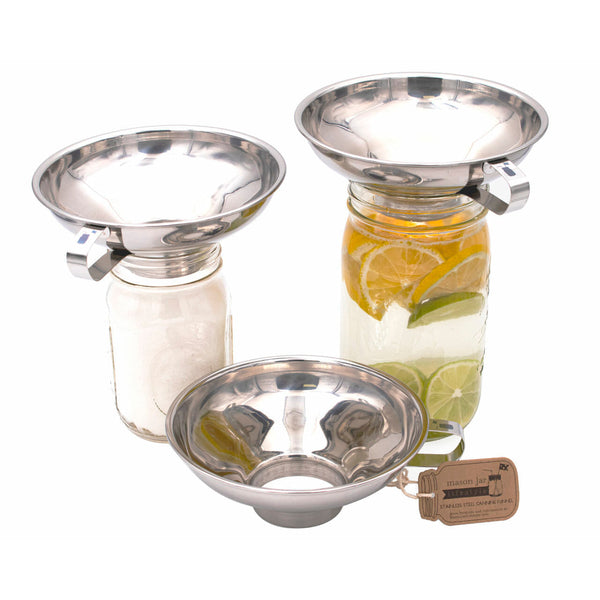 Set of three glass jars with metal lids, filled with water and fruit, on a white background.