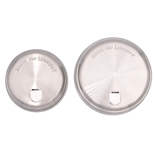 Two silver Mason jar lids on a white background