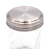 Glass jar with a silver metal lid on a white background. Transform your Mason jars with the Sugar Dispensing Stainless Steel Lids at Clozist. Rust-resistant, food-safe, and dishwasher safe. A durable 2-pack designed for easy pouring and sustainable kitchen organization. The perfect green gift for bakers and coffee lovers!