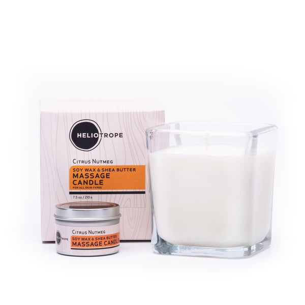 Glass massage candle with Heliotrope packaging on a white background