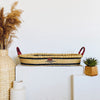 Meadow Changing Basket handwoven from elephant grass with navy plant-based dye, made in Ghana, shown with included mattress