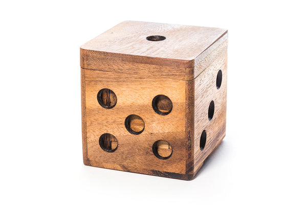 Wooden dice-shaped box with circular holes on a white background