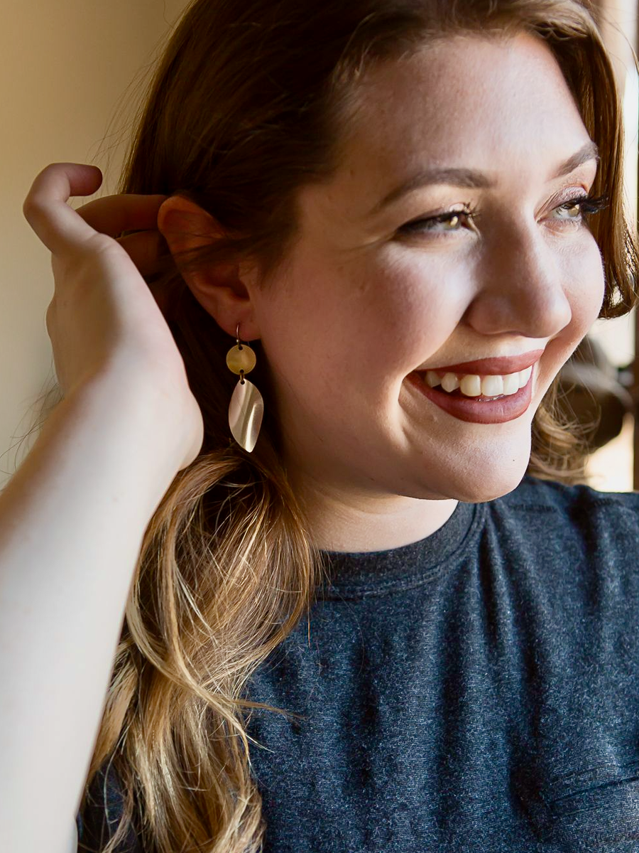 Close-up of mixed metal stacked disc earrings showing twisted organic shape, handcrafted by Fair Anita artisans in India