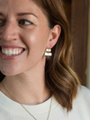 Close-up of mixed metal triple rectangle earrings made from recycled brass, silver, and copper-plated metal