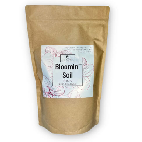 Kraft paper bag with 'Bloomin' Soil' label on a white background