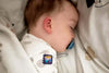 Baby sleeping with a pacifier in a crib