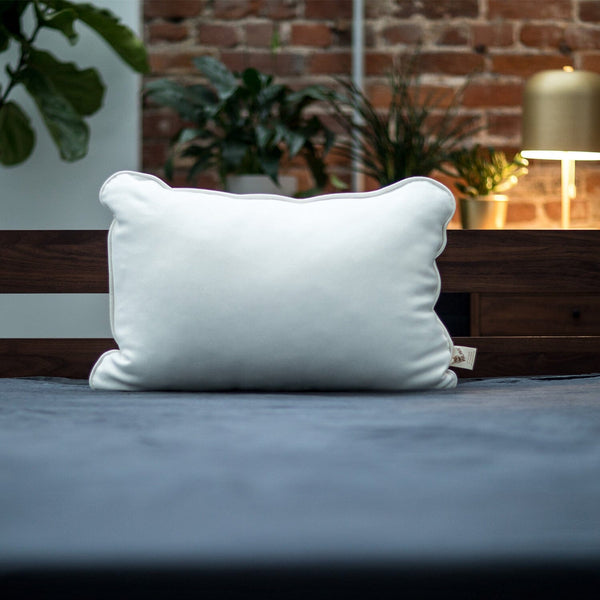 White pillow on a bed with a blurred background
