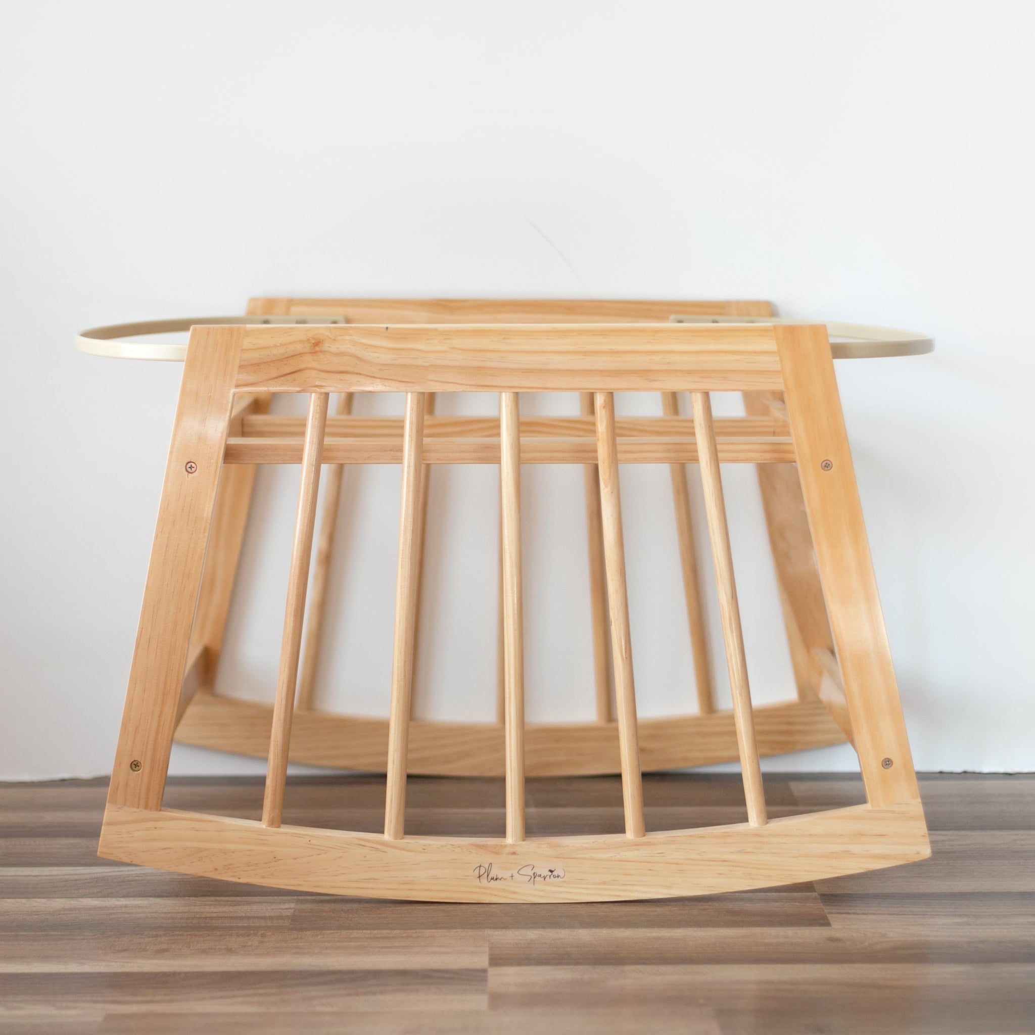 Wooden baby crib with a plain background