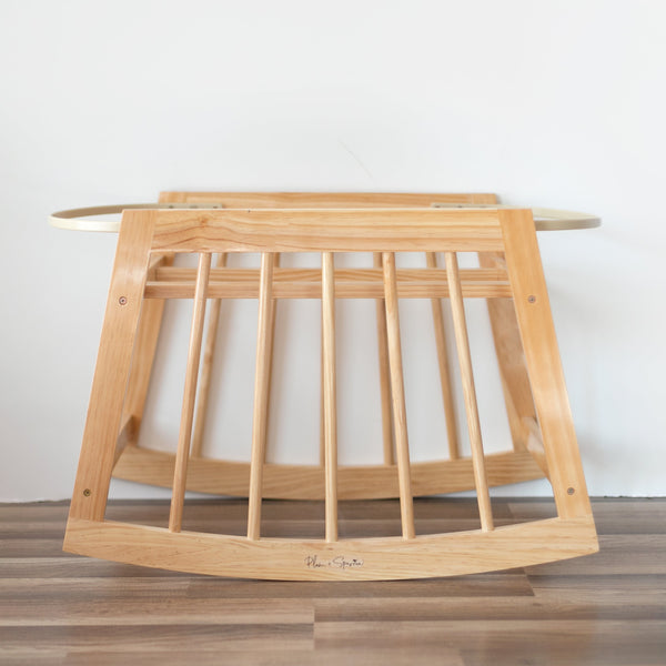 Wooden baby crib with a plain background