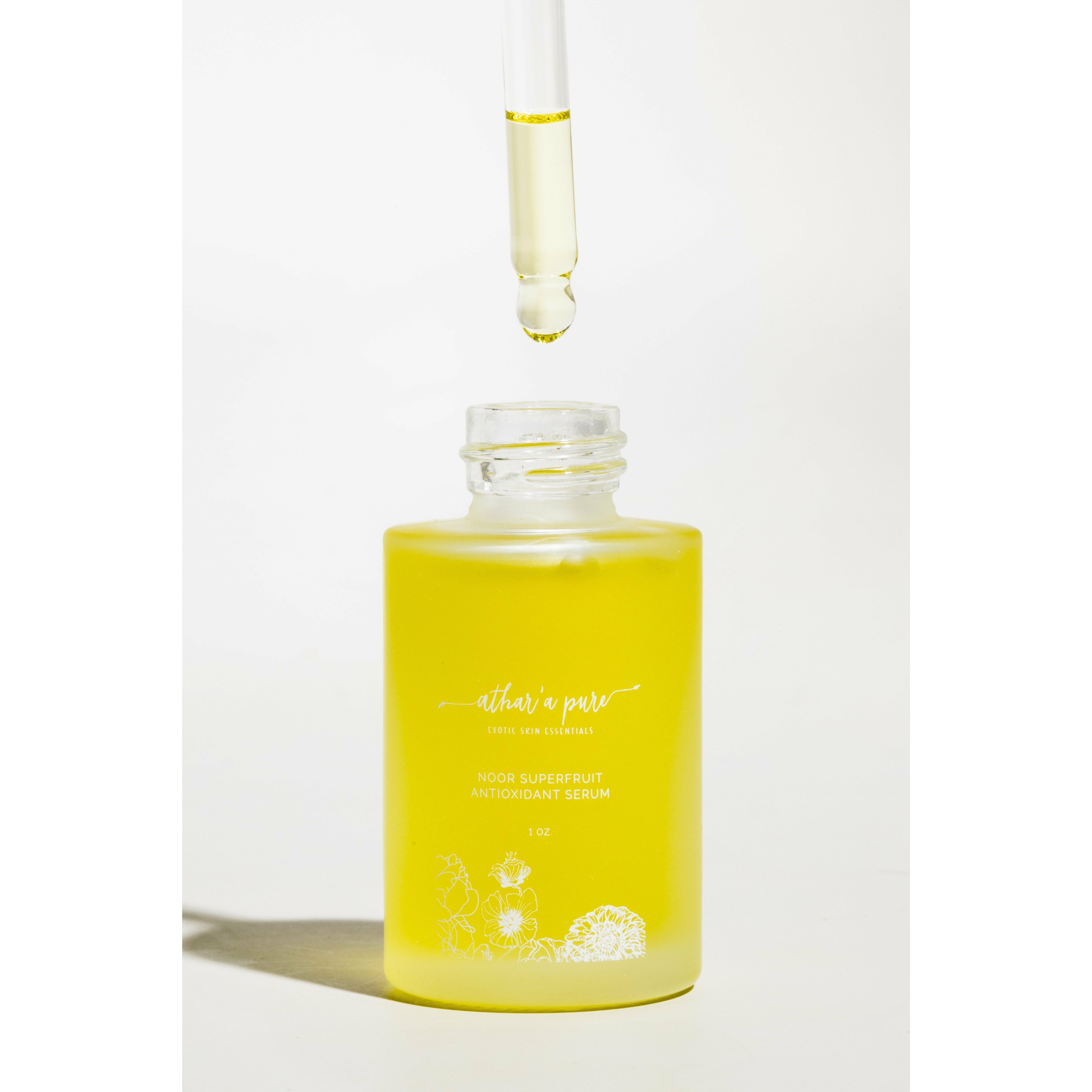 Yellow serum bottle with dropper on a white background