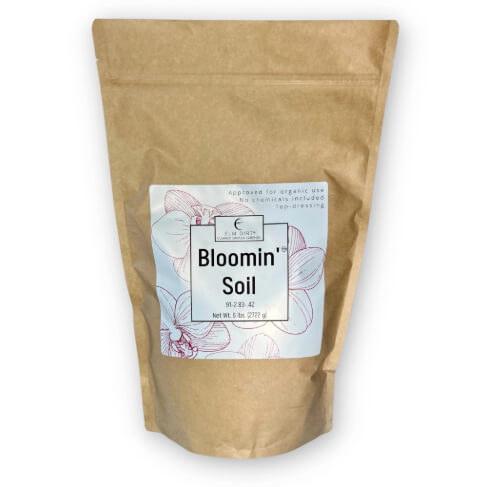 Kraft paper bag with 'Bloomin Soil' label on a white background