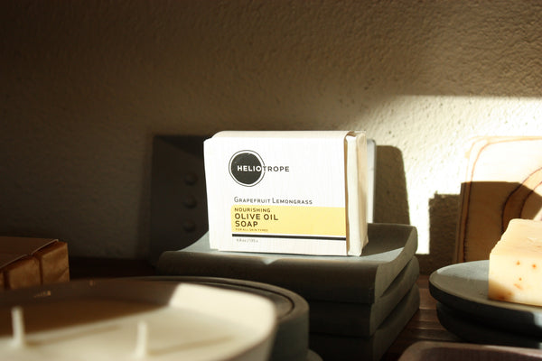 Bar of soap with 'Heliocrope' branding on a textured surface