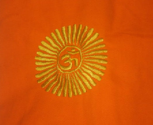 Embroidered symbol on orange fabric