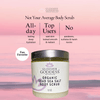 Glimmer Goddess Organic Dead Sea Salt Body Scrub jar on a pink and purple gradient background