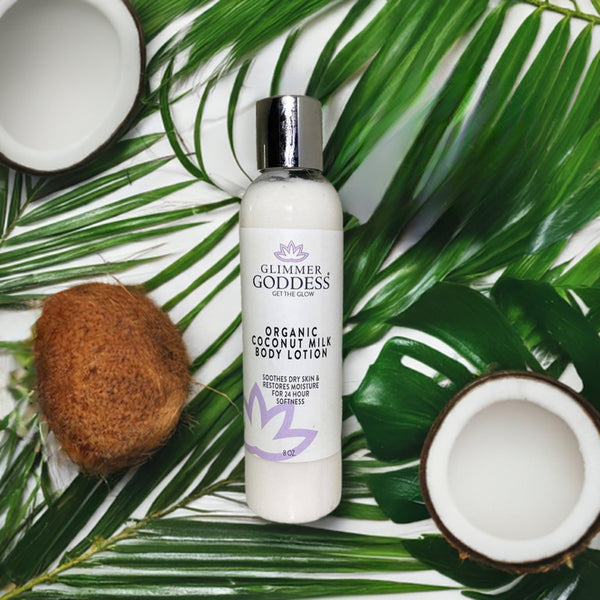 Organic body lotion with coconut milk displayed with natural ingredients including coconut and botanicals