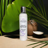 Glimmer Goddess organic coconut milk body lotion bottle with a coconut and leaves in the background