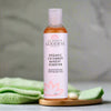 Bottle of Glimmer Goddess Organic Cucumber Makeup Remover on a neutral background