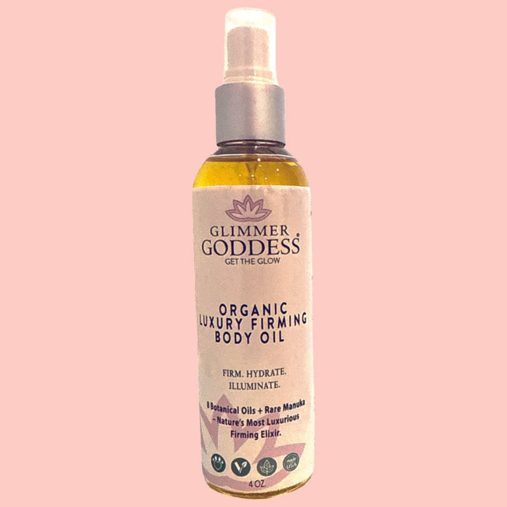 Glimmer Goddess organic body oil displayed with natural botanical ingredients including rosehip and evening primrose