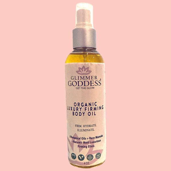 Glimmer Goddess organic body oil displayed with natural botanical ingredients including rosehip and evening primrose