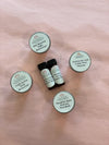 Organic anti-aging trial set flatlay showing cleanser, brightening serum, peptide eye serum, SPF moisturizer and night cream