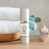 Close-up of Glimmer Goddess DMAE and alpha lipoic acid firming serum texture and packaging