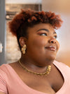 Close-up of Fair Anita In Bloom earrings showing flower shape and warm gold finish