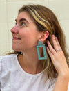 Close-up of oversized turquoise glass bead earrings with nickel-free ear wires by Fair Anita