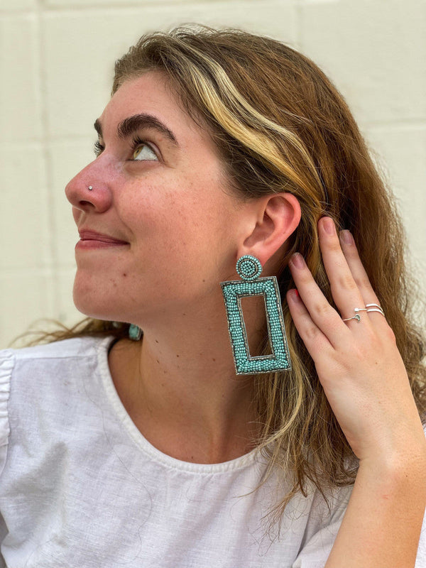 Close-up of oversized turquoise glass bead earrings with nickel-free ear wires by Fair Anita