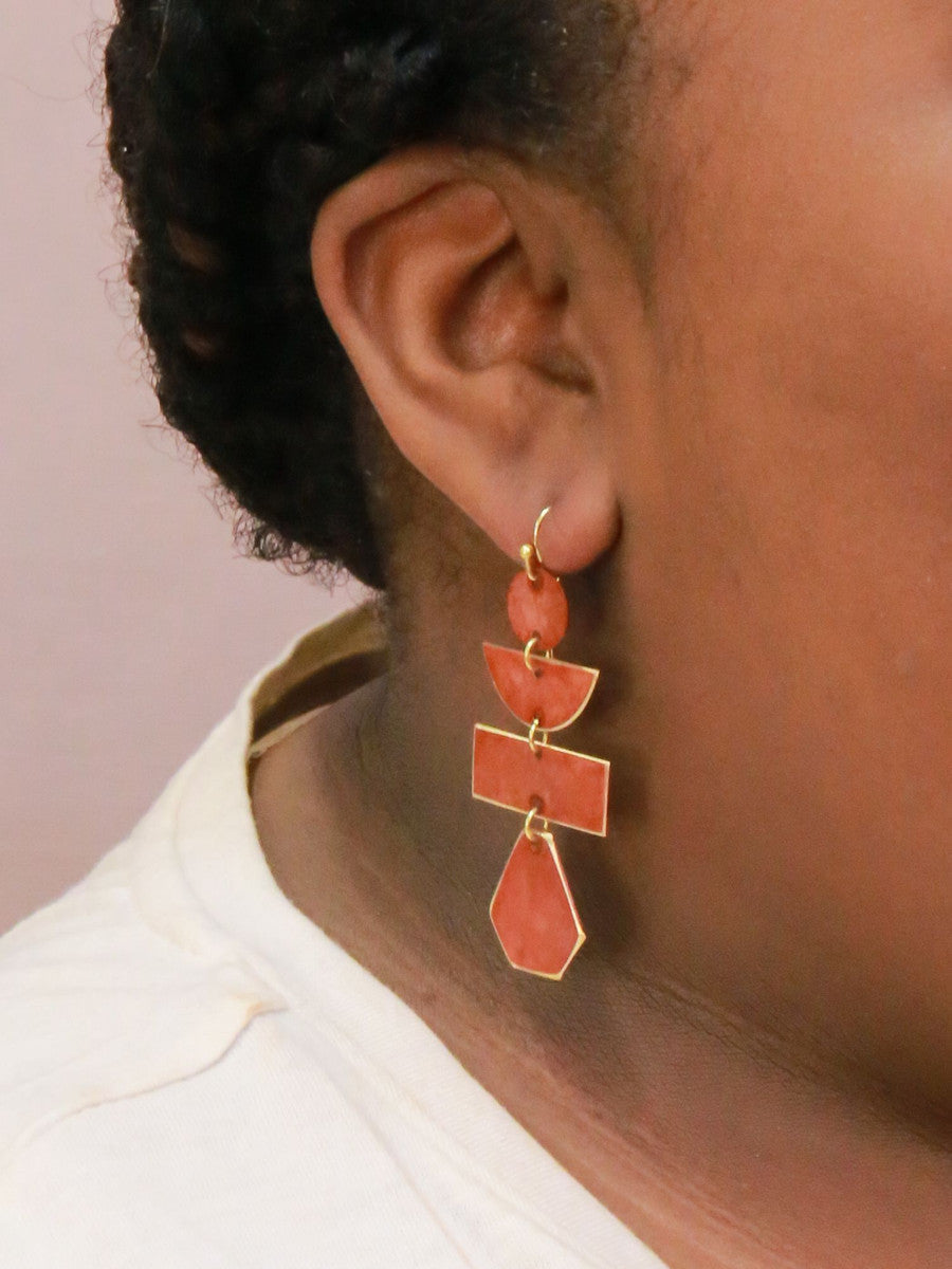 Close-up of Fair Anita pagoda painted earrings showing hand-painted mustard finish