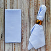 Pale blue seersucker dinner napkins set of 4 on a wooden table