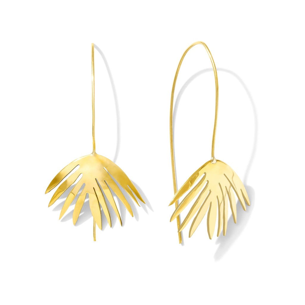 Gold leaf-shaped earrings on a white background