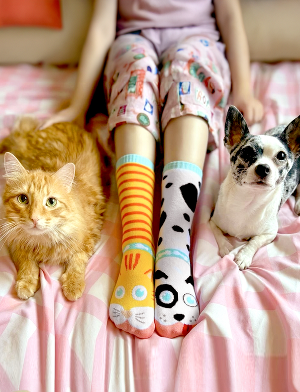 Add a playful touch to your wardrobe with these adorable mismatched cat and dog socks. These eco-friendly and comfortable socks are perfect for anyone who loves animals and unique style.