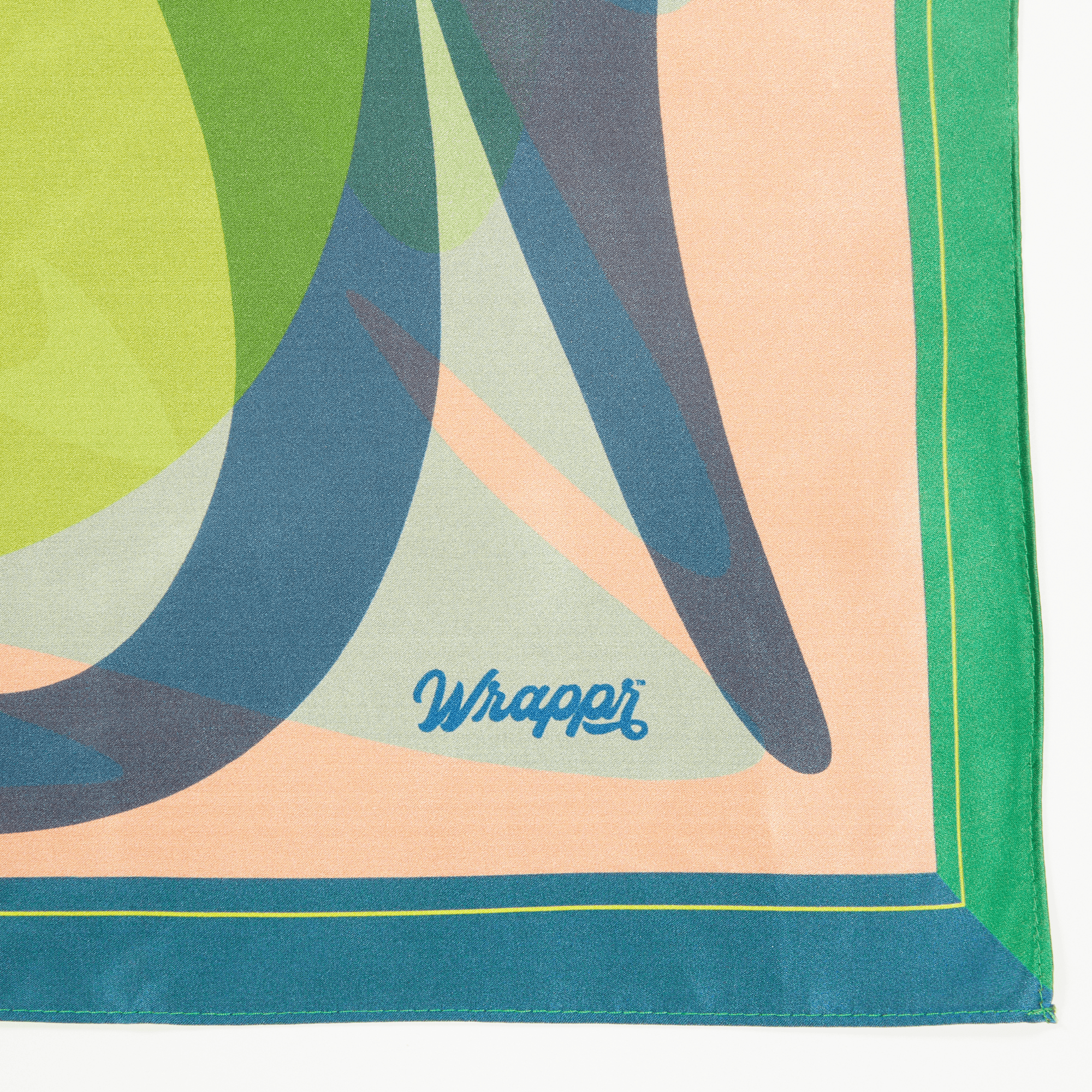 Colorful fabric with abstract patterns and 'Wrapper' branding on a white background