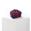 Patient Heart silk furoshiki wrap folded and tied as a reusable gift bag, styled as an eco-friendly gift wrapping option