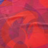 Abstract pattern of red and pink shapes on a fabric background