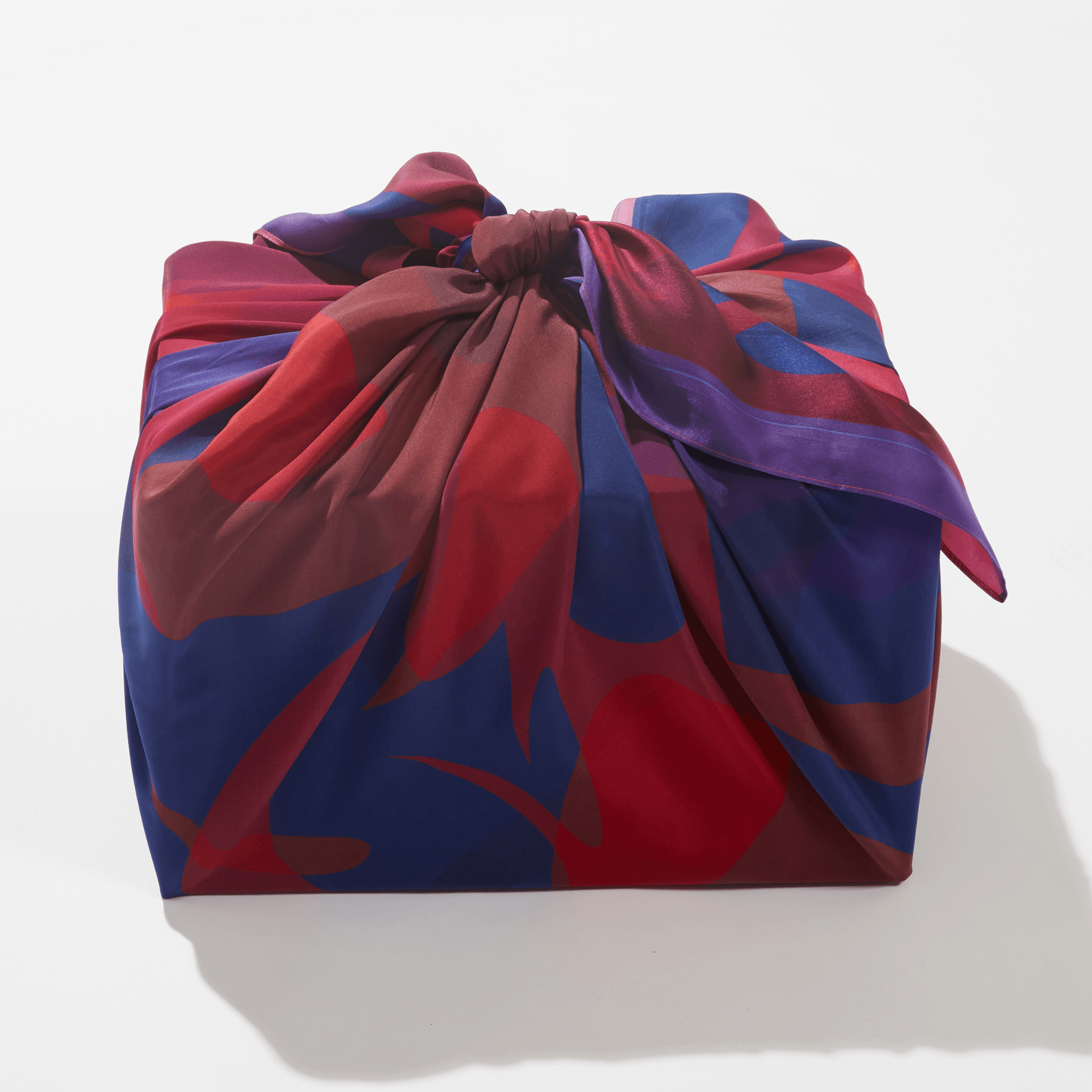 Colorful fabric bag with abstract pattern on a white background