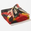 Colorful fabric package with a knot on a white background