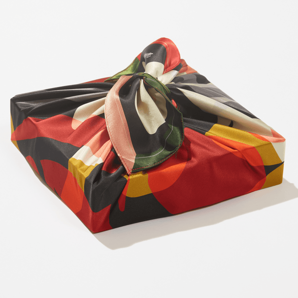 Colorful fabric package with a knot on a white background
