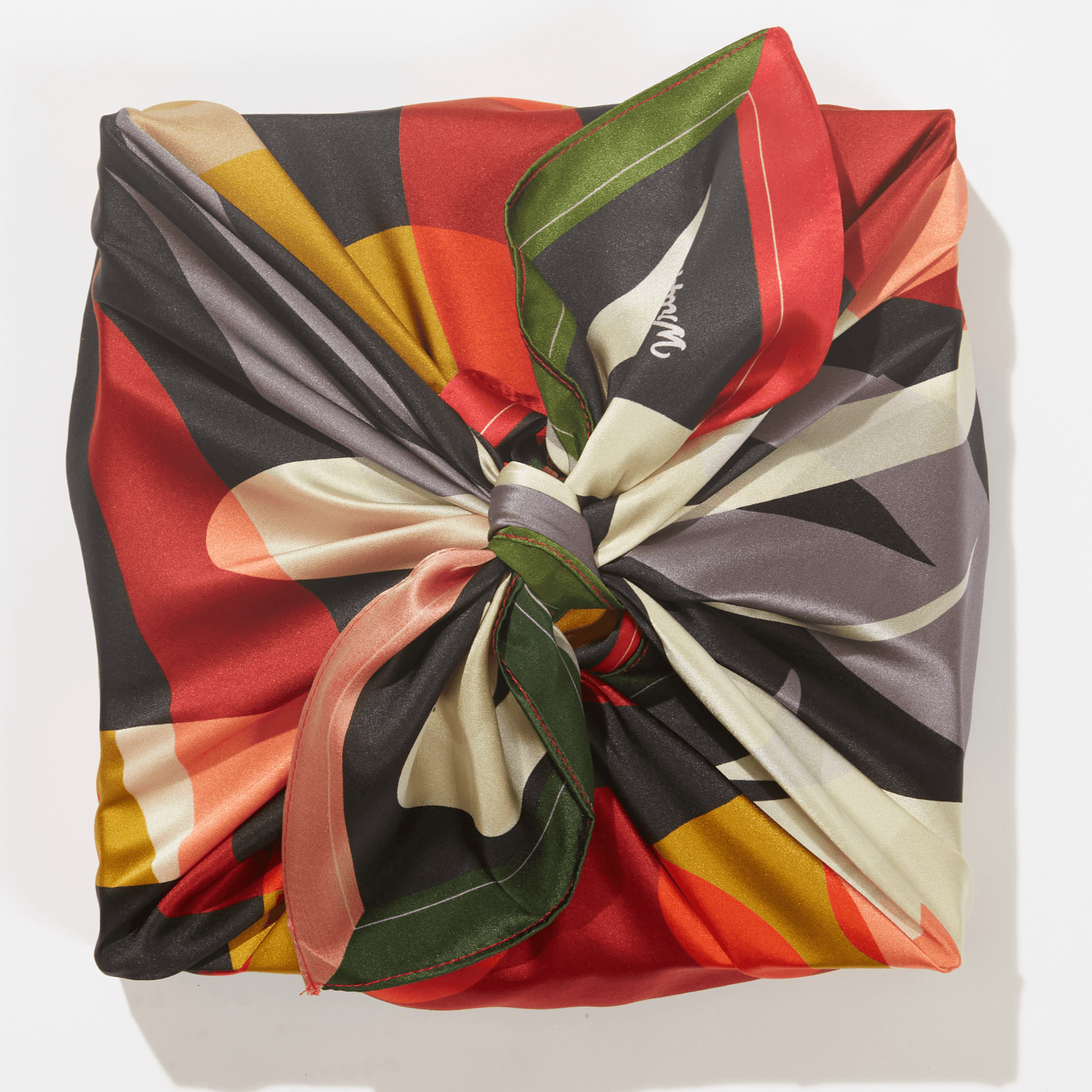 Colorful patterned scarf tied in a knot on a white background