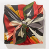 Colorful patterned scarf tied in a knot on a white background