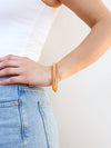 Close-up of peach multistrand sparkly glass bead bracelet by Fair Anita on white background