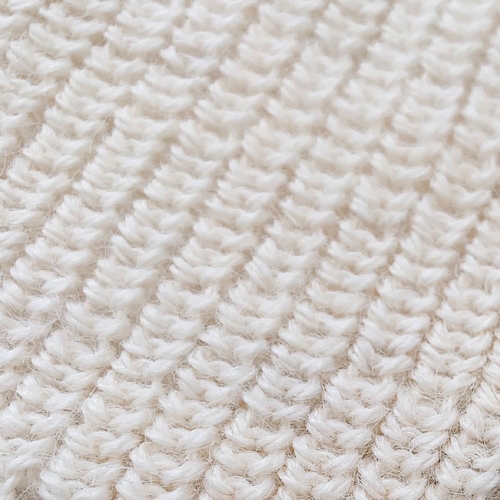 Handcrafted Peruvian baby alpaca beanie hat in pearl white, detail shot