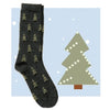 Dark gray sock with Christmas tree pattern on a light blue background with a stylized Christmas tree.