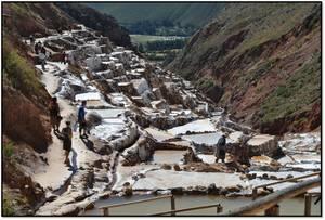 Salt pans with workers in a mountainous area