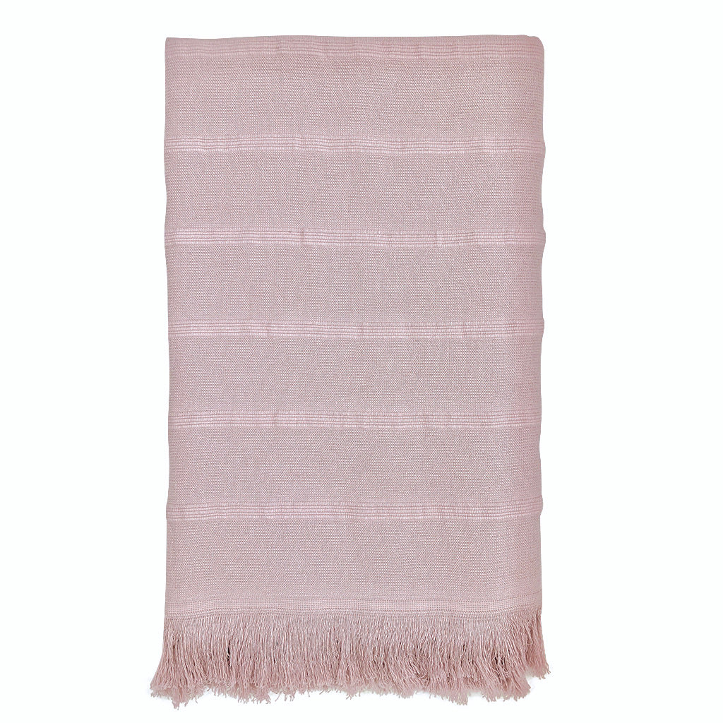 Pink textured rug with fringes on a white background
