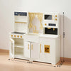 White toy kitchen set with gold accents on a wooden floor, dimensions indicated.