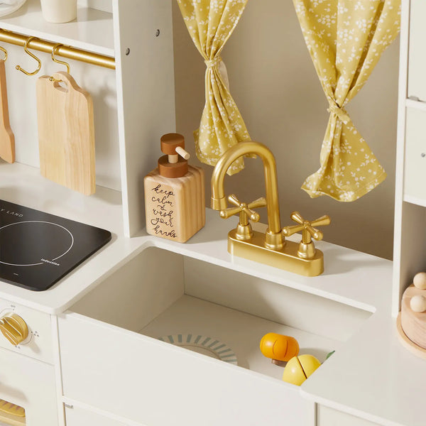 Tiny Land iconic wooden play kitchen in cream showing full layout with stovetop, oven and storage compartments