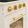 White oven with gold knobs and handle