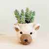 Handmade polar bear head planter made from natural coco coir, displayed with a small potted plant