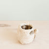 Close-up of handcrafted coco coir bear planter showing natural texture and white detailing